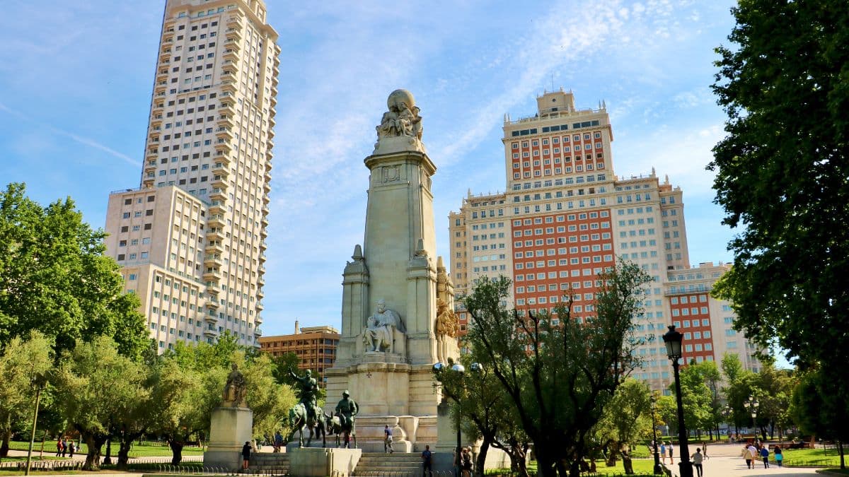 Monument to Cervantes at Plaza de España with surrounding modern towers.